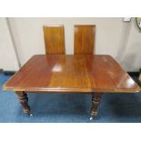 A 19TH CENTURY MAHOGANY PULL-OUT EXTENDING DINING TABLE WITH THREE ADDITIONAL LEAVES, raised on