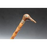 A NOVELTY WALKING STICK WITH CARVED BIRD HEAD POMMEL, L 84 cm