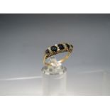 A HALLMARKED 9CT GOLD FIVE STONE SAPPHIRE HALF ETERNITY STYLE DRESS RING, ring size Q ½,