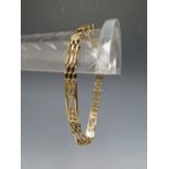 A 9CT GOLD THREE BAR ART NOUVEAU STYLE GATE BRACELET, the three bar links interspersed with Rennie