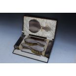A CASED HALLMARKED SILVER SIX PIECE DRESSING TABLE SET RETAILED BY KEMP & WILCOX GOLDSMITHS OF