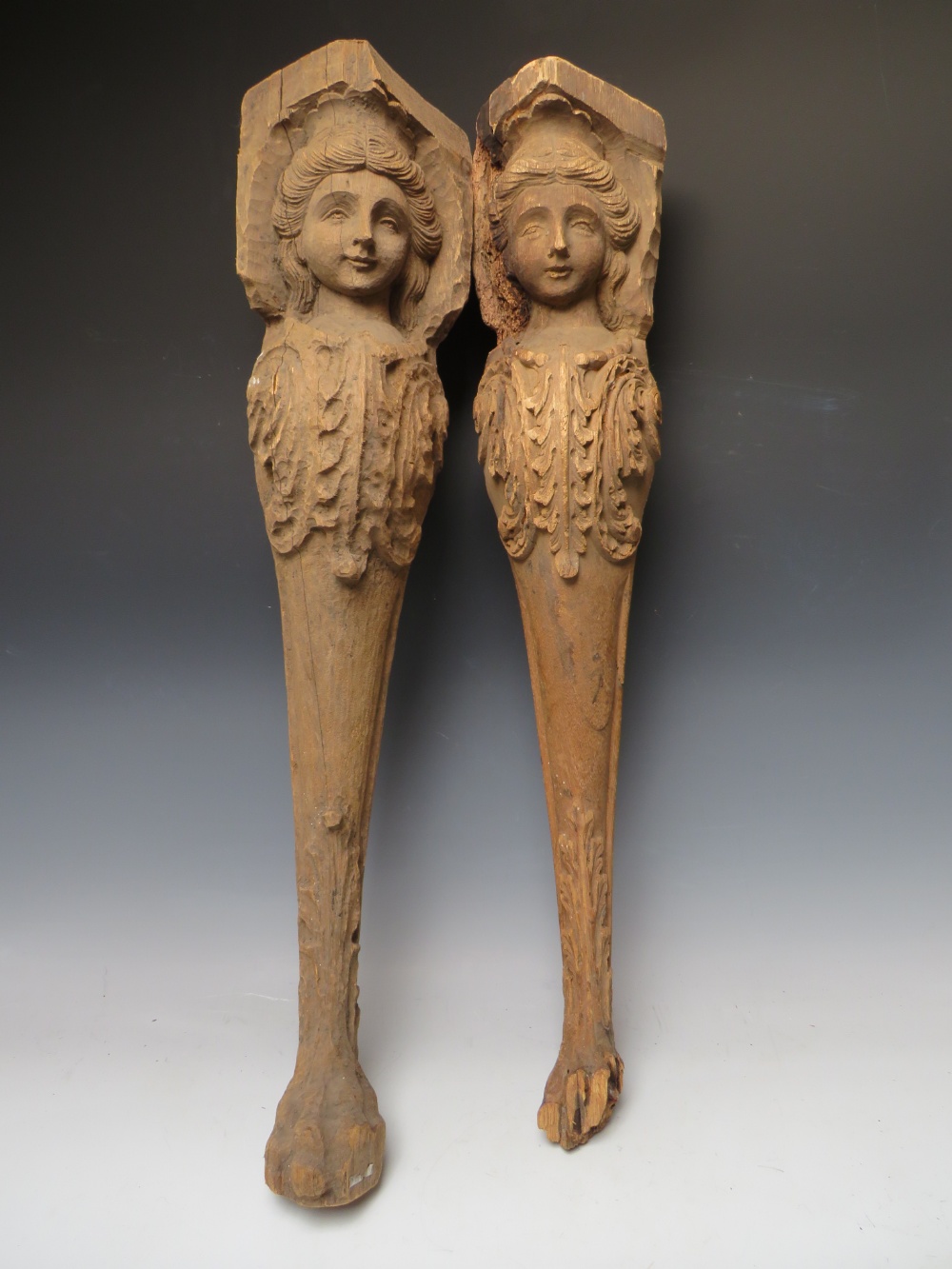 A PAIR OF LATE 17TH / EARLY 18TH CENTURY CARIATE TABLE LEGS A/F, with carved effigies of young