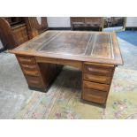 A LATE 19TH CENTURY TWIN PEDESTAL OAK PARTNERS DESK, having a brown inset leather writing surface,