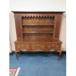 A GEORGE III OAK DRESSER WITH FULL PLATE RACK, the rack with two cupboards, the three drawer base