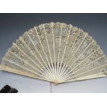 TWO ANTIQUE FANS, comprisong an ebonised example with sequin embellishment, L 33 cm, open W 62 cm