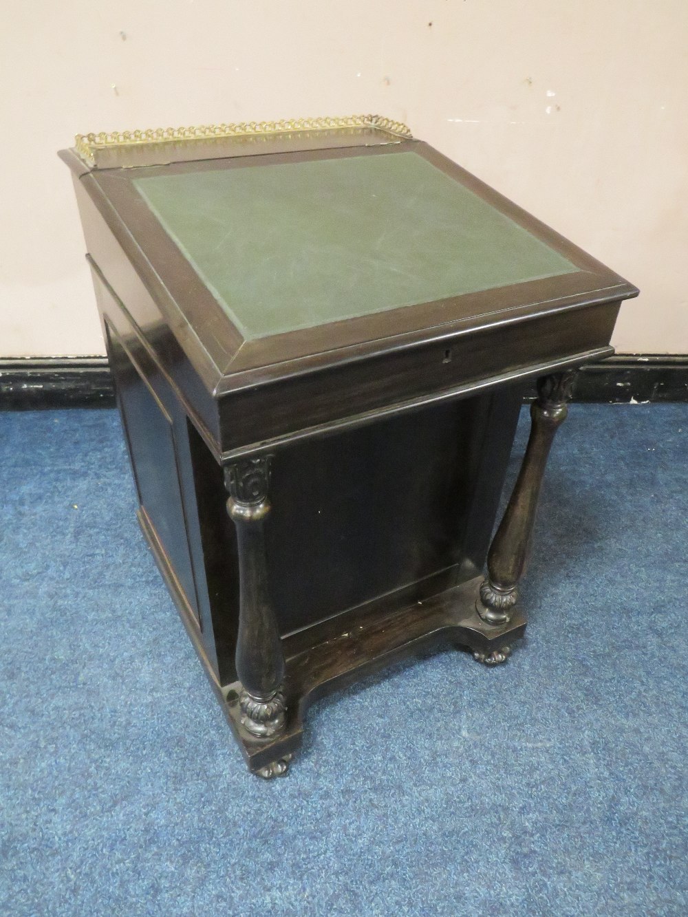 A 19TH CENTURY COLONIAL EBONY DAVENPORT DESK IN THE MANNER OF GILLOWS, the slope with brass gallery