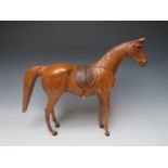 A LARGE VINTAGE LEATHER MODEL OF A HORSE, with saddle and tack, H 39 cm