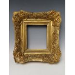 A SMALL 19TH CENTURY GILT DECORATIVE SWEPT FRAME, frame W 6.5 cm, rebate 16 x 14 cm