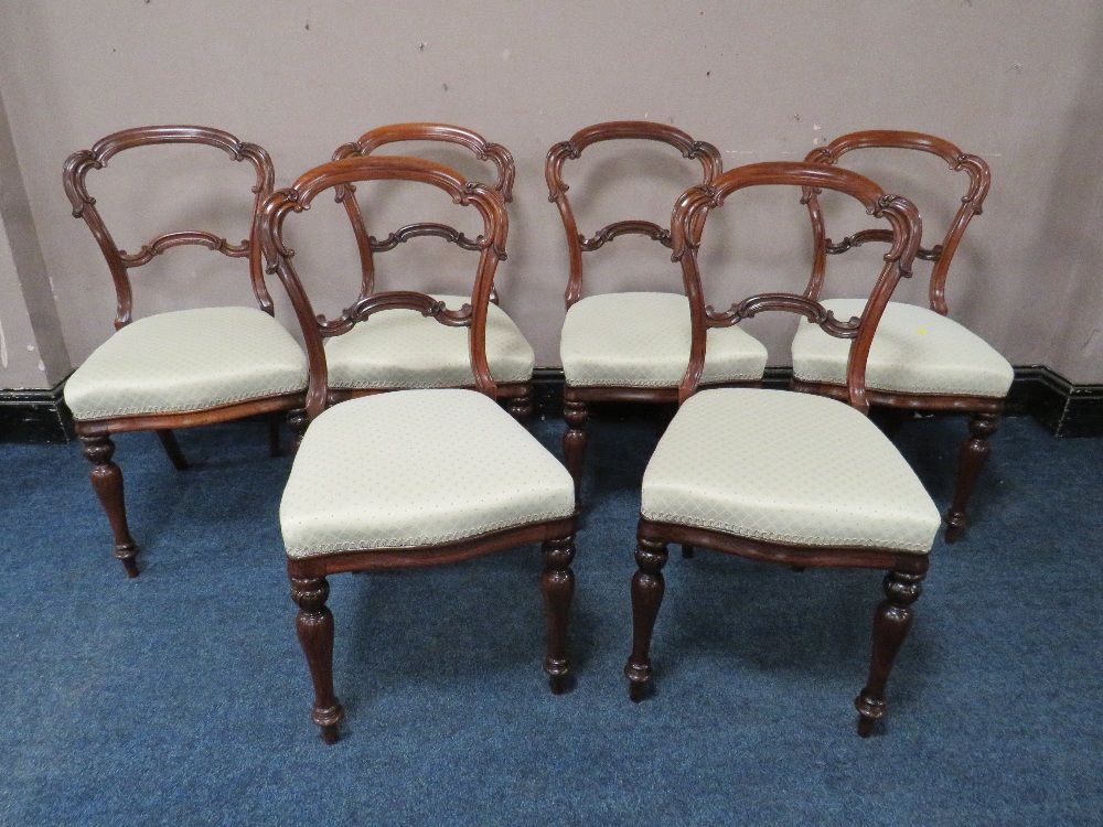 A SET OF SIX 19TH CENTURY ROSEWOOD CROWN BACK DINING CHAIRS, raised on shaped turned supports