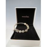 A PANDORA CHARM BRACELET WITH ATTACHED CHARMS, together with a collection of empty Pandora boxes (
