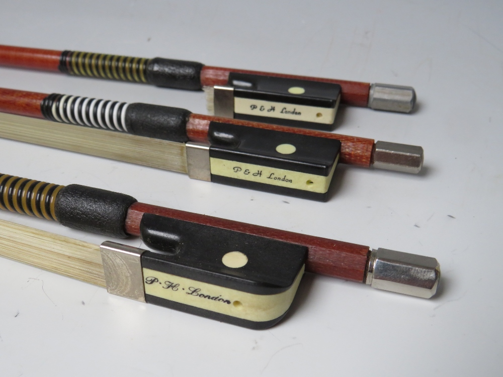 THREE GLASS FIBRE VIOLIN BOWS, one marked P H London, the other tow marked P & H LondonCondition