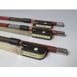 THREE GLASS FIBRE VIOLIN BOWS, one marked P H London, the other tow marked P & H LondonCondition