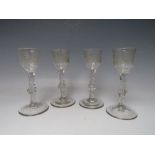 A SET OF FOUR LATE 18TH CENTURY GEORGIAN WINE GLASSES, each having bowl engraved with Oriental and