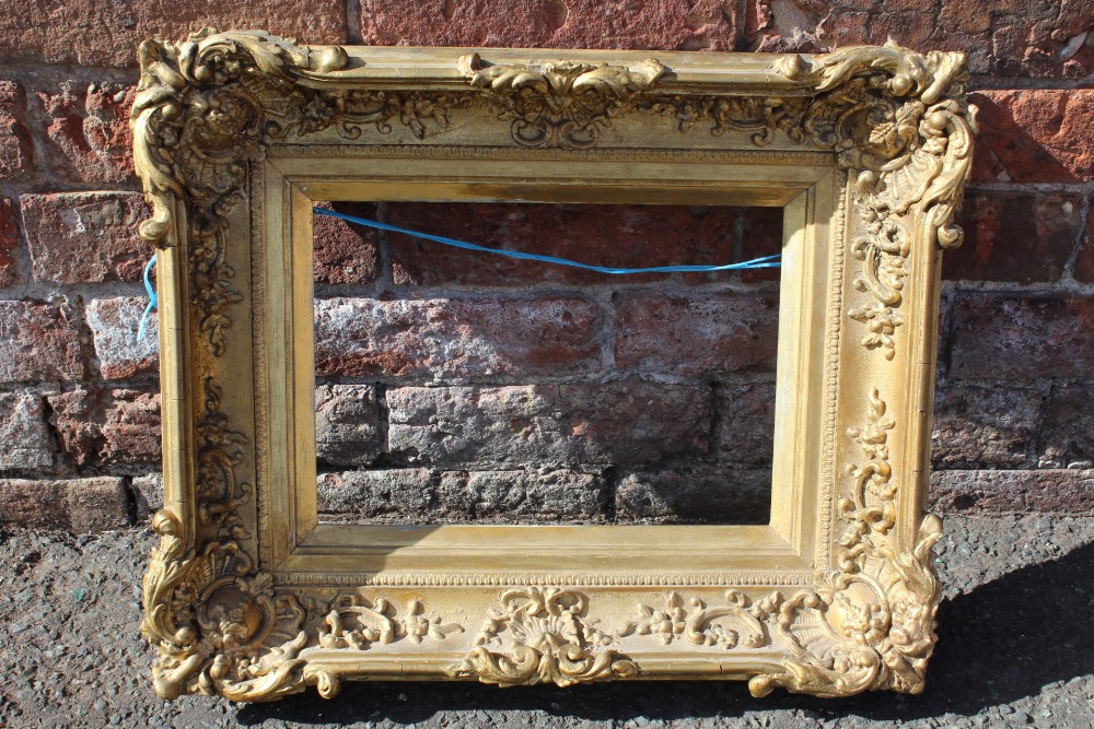 AN 18TH CENTURY DECORATIVE GOLD SWEPT FRAME WITH GOLD SLIP, frame W 8.5 cm, 26 x 36 cm