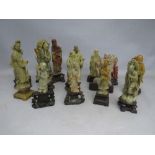 A COLLECTION OF TALLER ORIENTAL CARVED SOAPSTONE FIGURES / DEITIES, each figure mounted on a