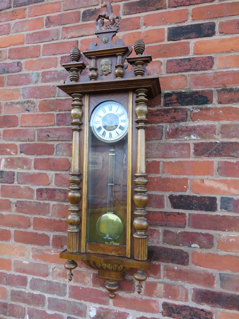 A LARGE GONG STRIKE VIENNA WALL CLOCK, the tall case comprising of oak pillars, mahogany veneered