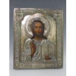 A 19TH CENTURY RUSSIAN ICON WITH WHITE METAL OKLAD, inscribed verso 'To The Spiritual Leader of