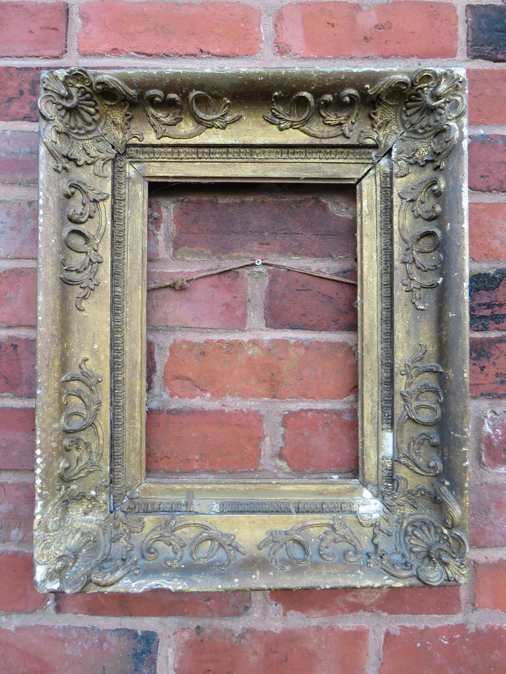 A LATE 18TH / EARLY 19TH CENTURY DECORATIVE GOLD FRAME, with corner embellishments and gold slip, in