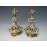 A PAIR OF CONTINENTAL FLORAL ENCRUSTED PORCELAIN SCENT BOTTLES / VASES AND COVERS, H 24 cm, S/D