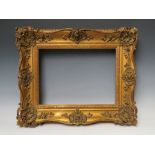 A 19TH CENTURY GOLD SWEPT FRAME, frame W 9 cm, rebate 29 x 39 cm