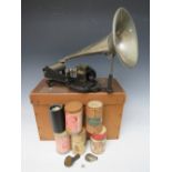 A BOXED PUCK CYLINDER PHONOGRAPH WITH A SELECTION OF WAX CYLINDERS, the cast iron lyre shaped base