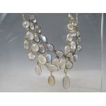 A WHITE METAL AND MOONSTONE TYPE 'DROPPER' NECKLACE, together with a similar gold tone example (2)