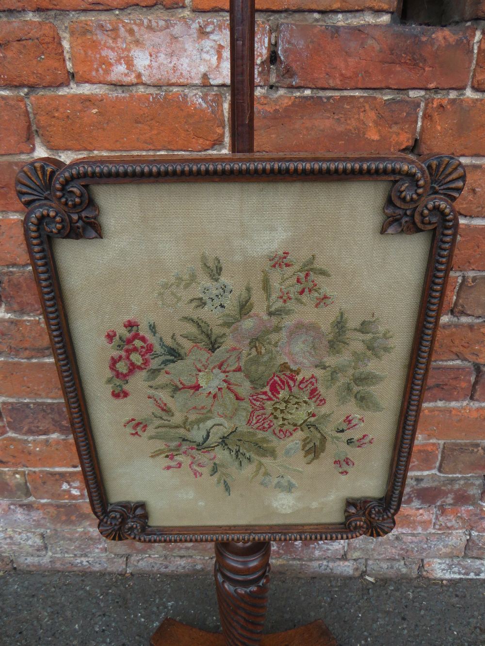 A 19TH CENTURY MAHOGANY POLE SCREEN, having a shaped glazed needlepoint adjustable floral screen, - Image 2 of 3