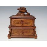 A VINTAGE BLACK FOREST MINIATURE SET OF DRAWERS, with carved bird surmount, H 16 cm, W 14 cm, D 7