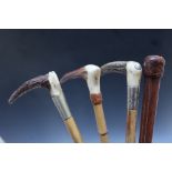 A SELECTION OF FOUR VINTAGE RIDING CROPS, to include a Swayne and Adeney example, longest 67 cm