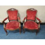 A PAIR OF 19TH CENTURY MAHOGANY CARVED OPEN ARMCHAIRS, in the Louis XV style, original castors