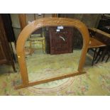 A CARVED ARCHED PINE OVERMANTEL MIRROR H-98 W-123 CM