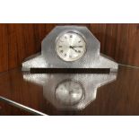 AN ARTS AND CRAFTS STYLE HAMMERED EFFECT PEWTER CASED MANTEL CLOCK