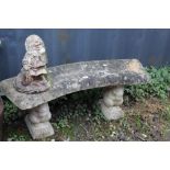 A CURVED CONCRETE GARDEN BENCH WITH A GNOME (2)