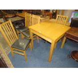 A MODERN LIGHT OAK FOLD-OVER KITCHEN TABLE AND FOUR CHAIRS
