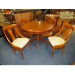 A MODERN CHERRY EXTENDING DINING TABLE AND FOUR CHAIRS