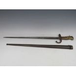 A 19TH CENTURY FRENCH BAYONET, in metal scabbard, inscribed on top edge of blade and dated 186,
