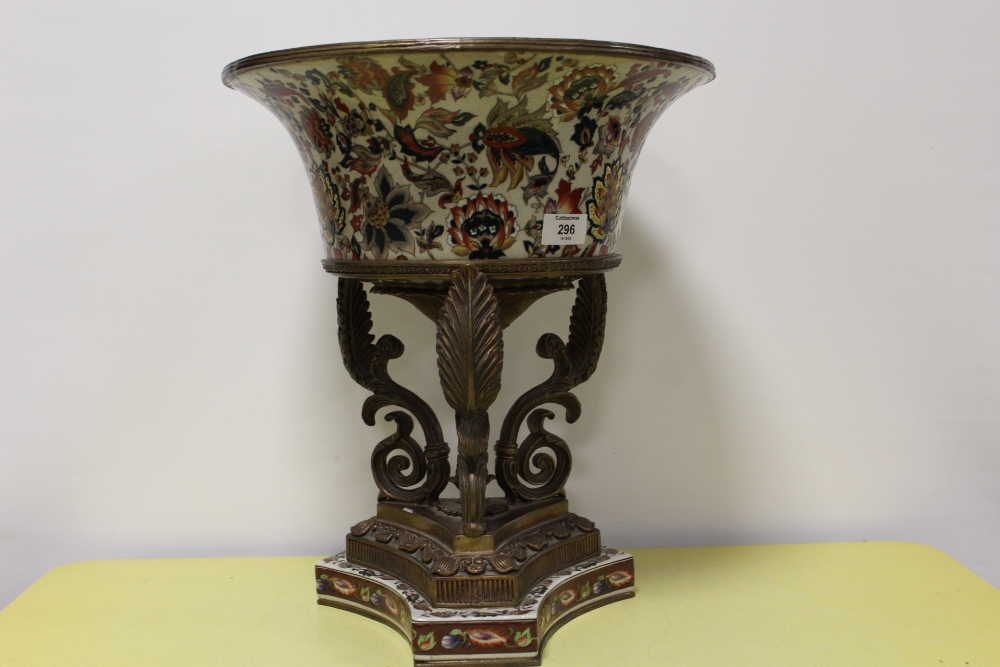 A LARGE AND IMPRESSIVE CONTINENTAL STYLE CERAMIC TABLE CENTREPIECE ON ACANTHUS SCROLL METAL BASE