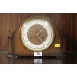 A VINTAGE OAK CASED MANTEL CLOCK