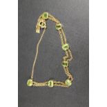 AN 18CT GOLD TWO STRAND BRACELET SET WITH EIGHT PERIDOT STYLE STONES - APPROX WEIGHT 7.9 G