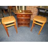 A SMALL THREE DRAWER CHEST AND TWO RETRO STOOLS (3)