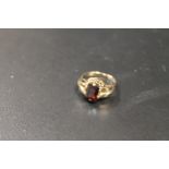 A 9CT DRESS RING SET WITH A GARNET TYPE STONE - APPROX WEIGHT 3.1 G