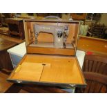 A CASED SINGER ELECTRIC SEWING MACHINE