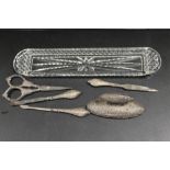 AN ANTIQUE SILVER MANICURE SET AND TRAY