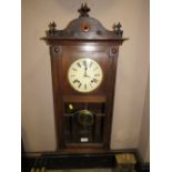 AN EDWARDIAN OAK CASED WALLCLOCK