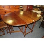 A SOLID MAHOGANY DROPLEAF DINING TABLE