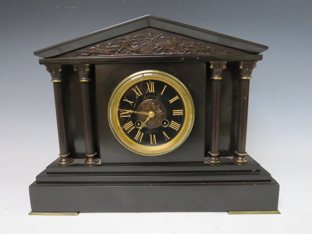 A BLACK SLATE GONG STRIKE MANTLE CLOCK, of architectural form with reeded columns and a black