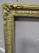 A 19TH CENTURY DECORATIVE GOLD FRAME WITH CORNER EMBELLISHMENTS, with some restoration, frame W 9.5,