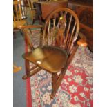 A CHILDS ERCOL DARK ROCKING CHAIR