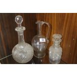 A CUT GLASS BANDED NECK DECANTER AND ANOTHER TOGETHER WITH A GLASS EWER (3)