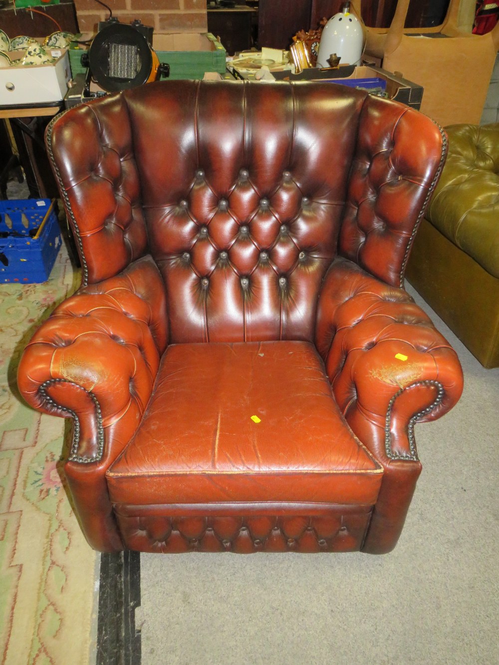 AN OXBLOOD LEATHER CLUB STYLE ARMCHAIR